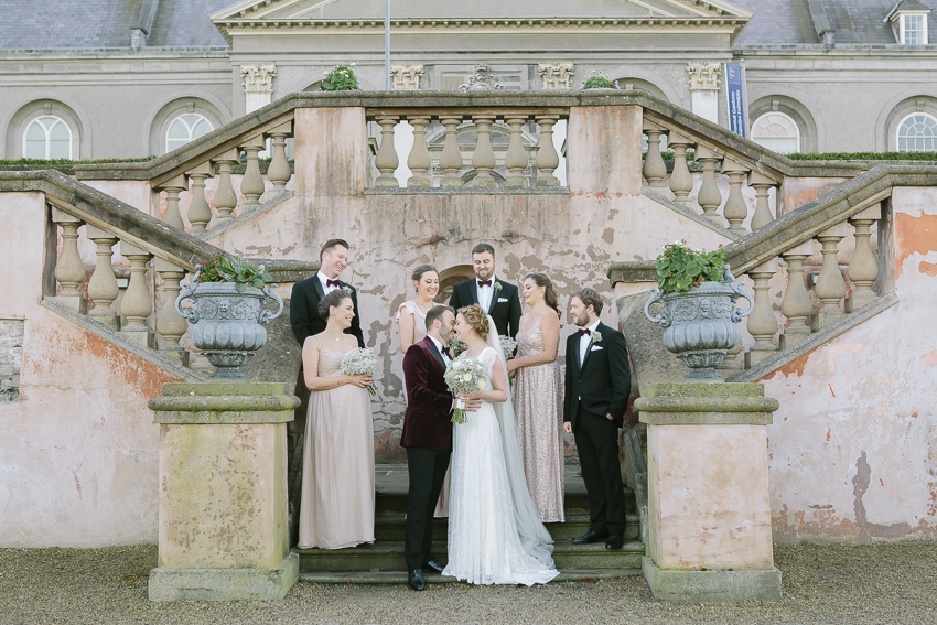 Group photo of the wedding party outside in the gardens of the royal hospital kilmainham. It has a real Mediterranean look, even taken in the middle of winter