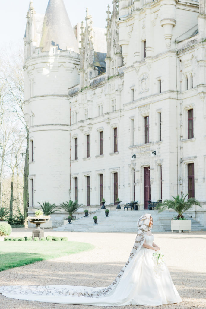 Bright romantic bride in front of Château Challain
