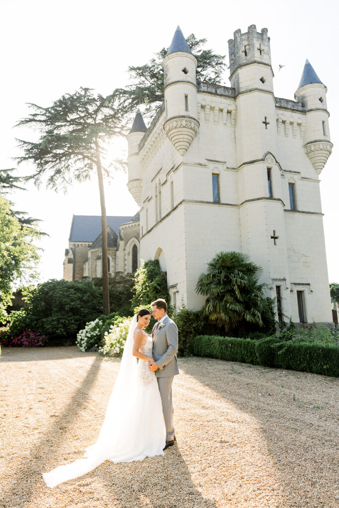 Couple enjoying an intimate French elopement at a château in the warm evening sun