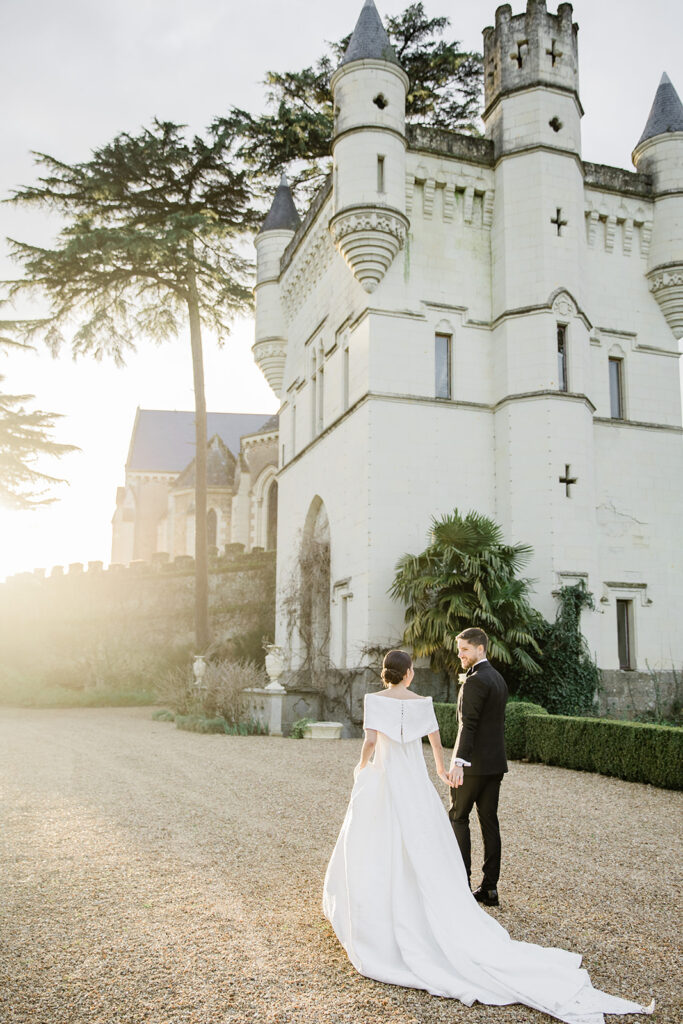 Lisette and Matthew walking at Château de Challain wedding France