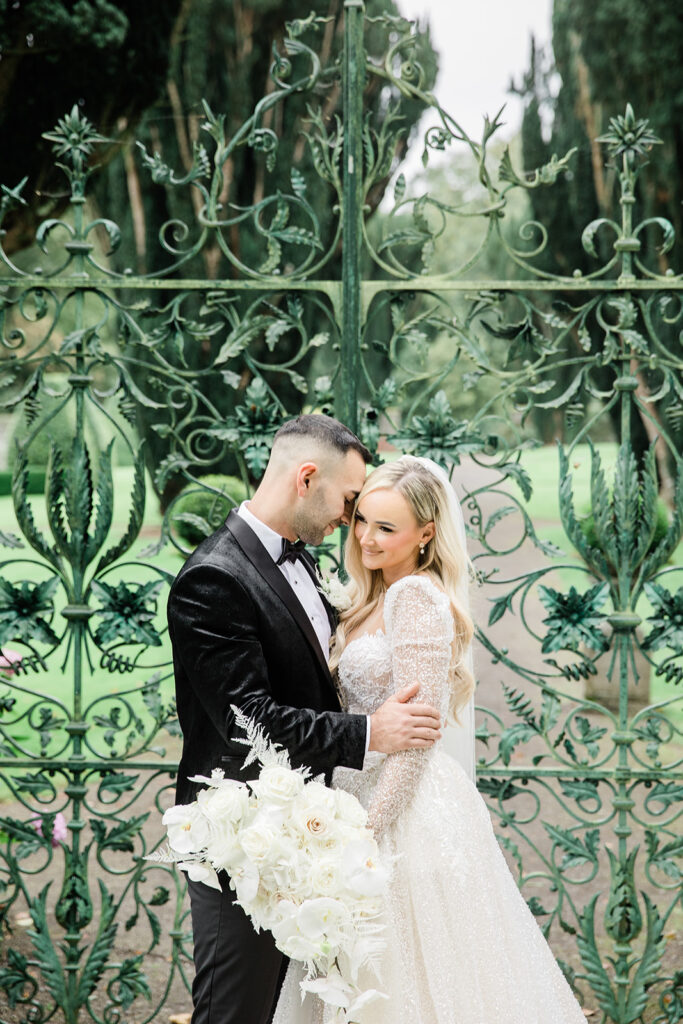 couple protrait at the famous gate in the gardens of Tankardstown House