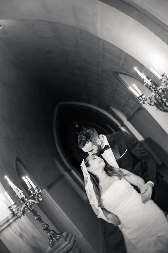 Bride and groom during a candlelit portrait session inside a French château