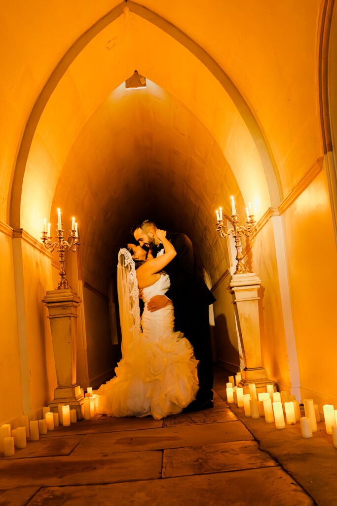 a couple embracing eachother during a shoot lit with candles at a chateau in france